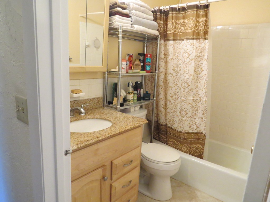 188 Swanson Road, Unit 336 Boxborough, MA 01719 - Photo 13 of 19 a bathroom with a granite countertop sink toilet and shower