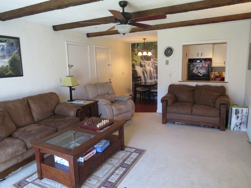 188 Swanson Road, Unit 336 Boxborough, MA 01719 - Photo 2 of 19 a living room with furniture a flat screen tv and a table