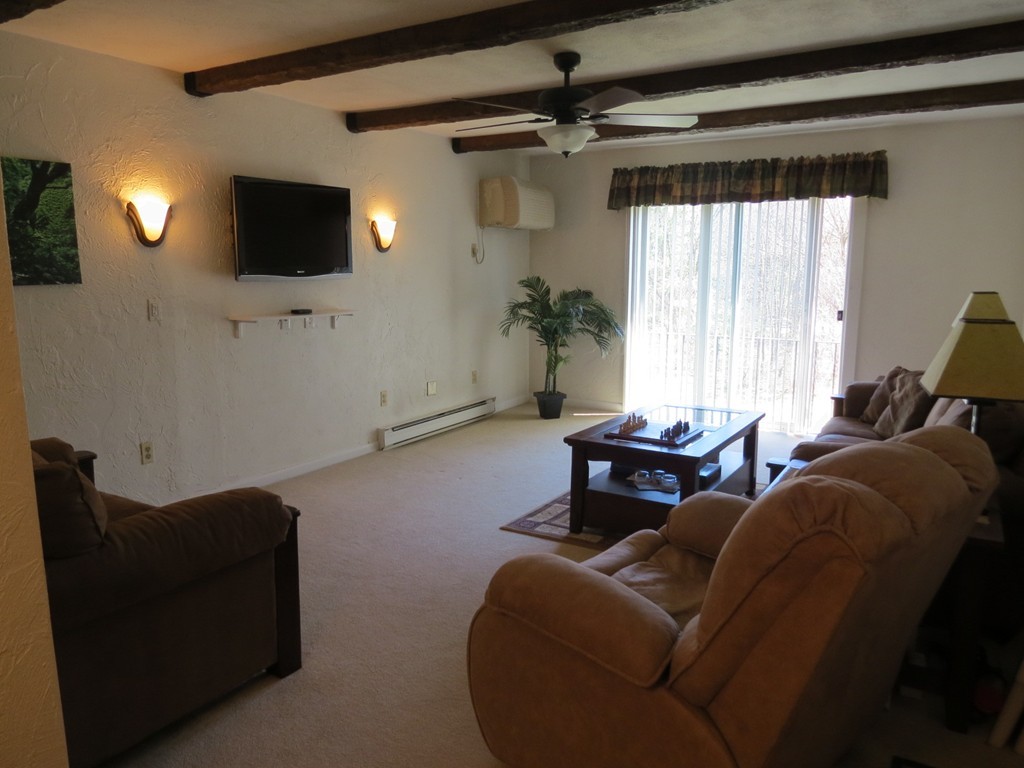 188 Swanson Road, Unit 336 Boxborough, MA 01719 - Photo 3 of 19 a living room with furniture and a flat screen tv