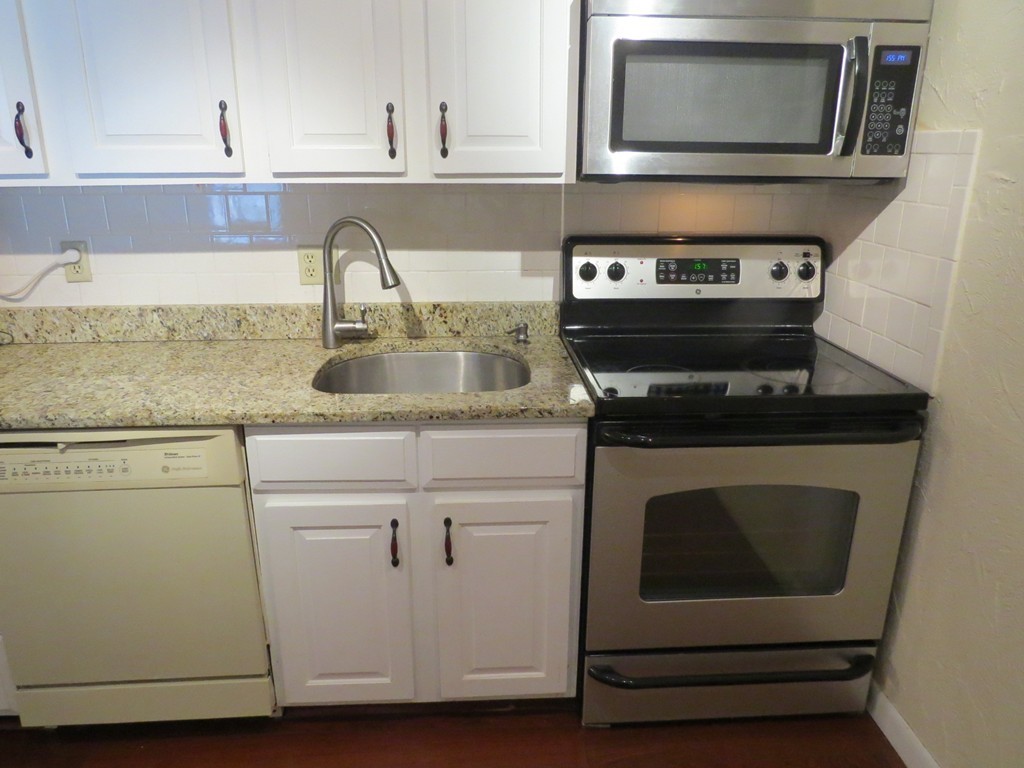188 Swanson Road, Unit 336 Boxborough, MA 01719 - Photo 8 of 19 a kitchen with appliances a sink and cabinets