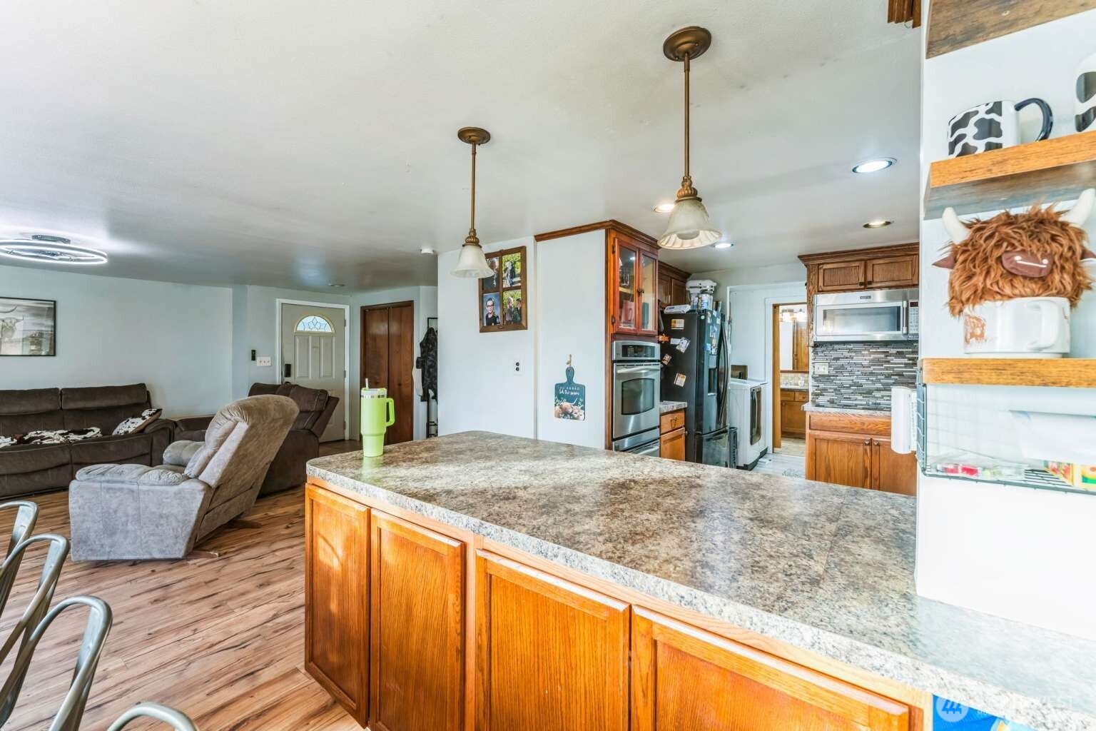 10068 Idano Road Northeast Moses Lake, WA 98837 - Photo 20 of 40 a kitchen with stainless steel appliances granite countertop a sink and a wooden floor