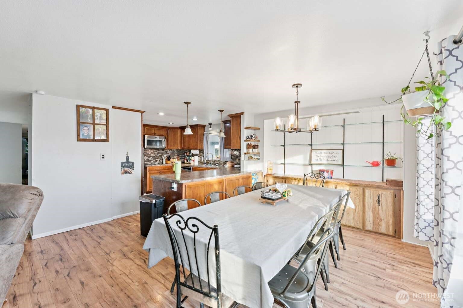 10068 Idano Road Northeast Moses Lake, WA 98837 - Photo 22 of 40 a view of a dining room with furniture and wooden floor