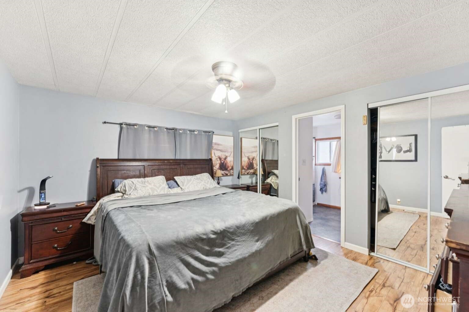 10068 Idano Road Northeast Moses Lake, WA 98837 - Photo 24 of 40 a bedroom with a bed and a chandelier