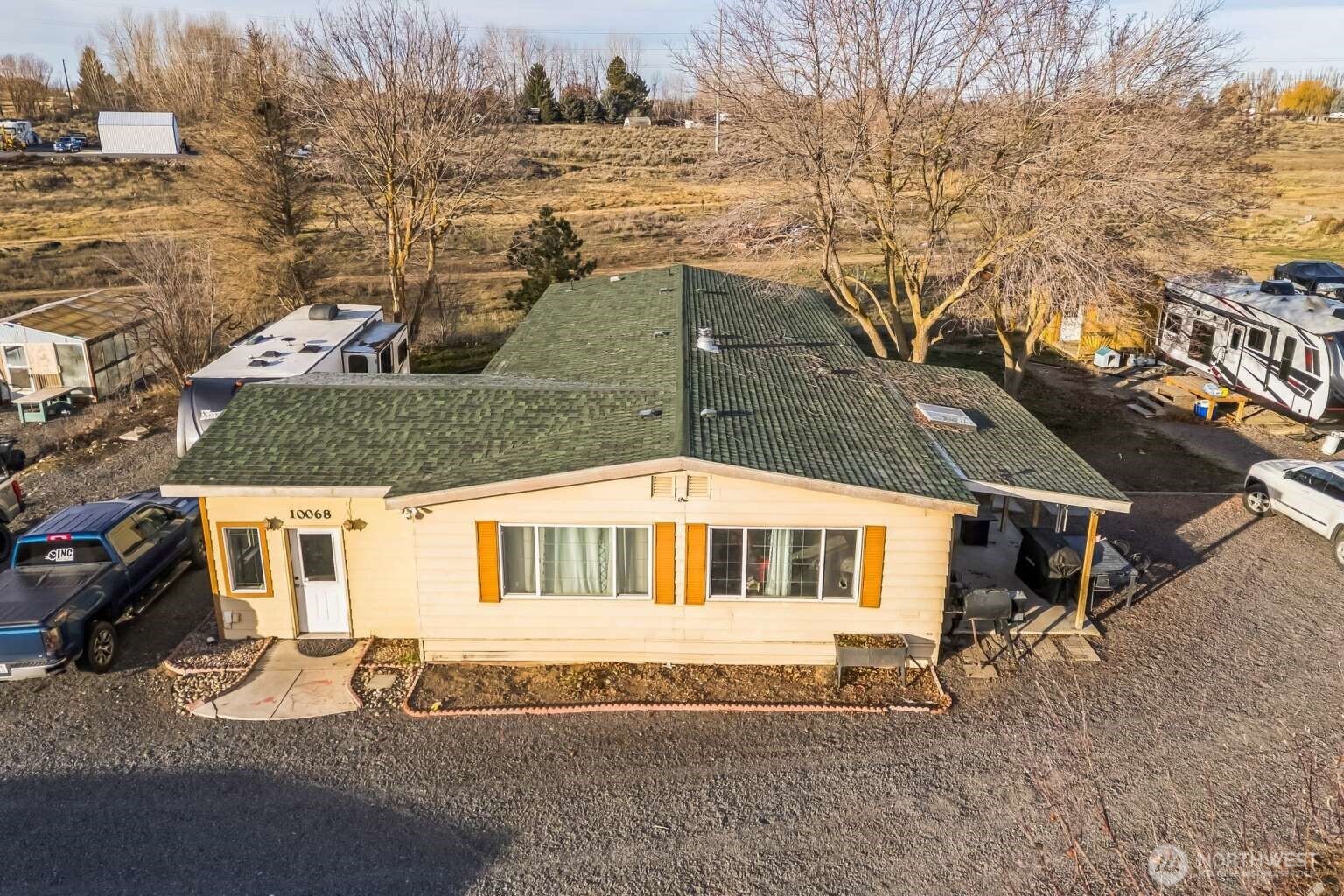 10068 Idano Road Northeast Moses Lake, WA 98837 - Photo 7 of 40 a front view of a house with a yard