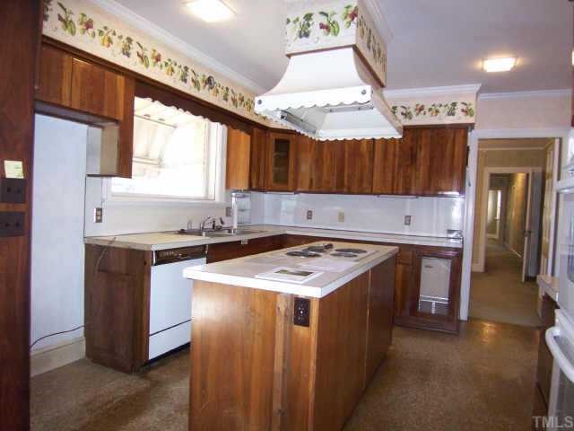 1402 Brooks Avenue Raleigh, NC 27608 - Photo 6 of 12 a kitchen with stainless steel appliances granite countertop a stove a sink and a refrigerator