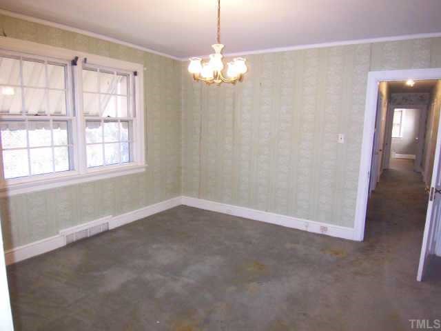 1402 Brooks Avenue Raleigh, NC 27608 - Photo 8 of 12 an empty room with chandelier fan and windows