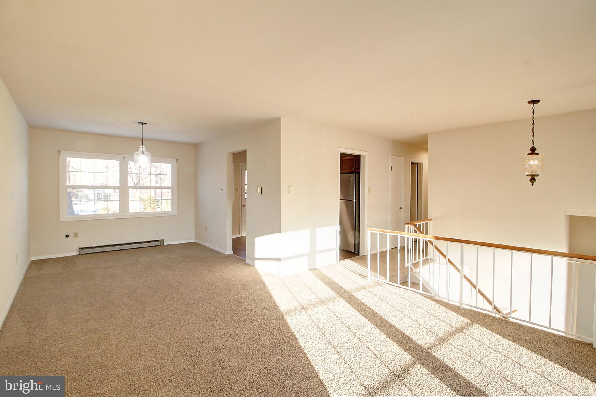 1411 West 12th Street Frederick, MD 21702 - Photo 4 of 16 a view of a bedroom with wooden floor and windows