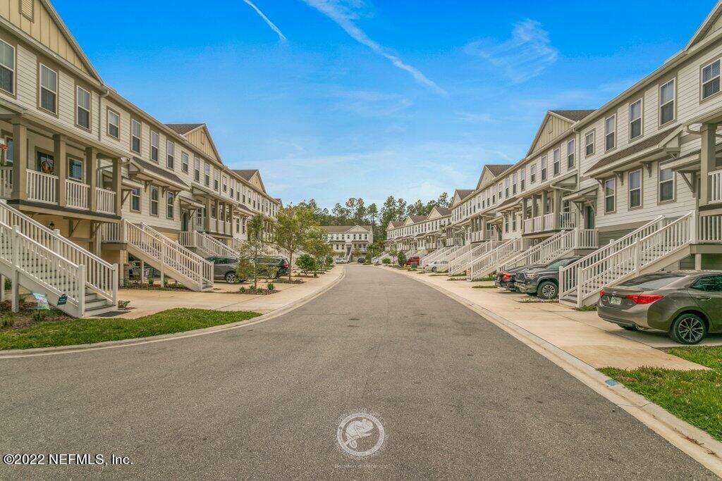 127 Spring Tide Way Ponte Vedra, FL 32081 - Photo 54 of 64 a city view with tall buildings and cars parked on the side of road