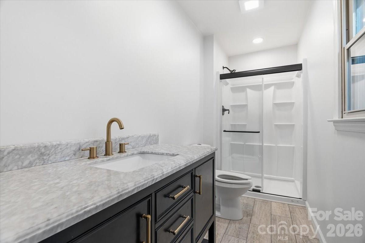 14 Jack Sullins Road Spruce Pine, NC 28777 - Photo 27 of 37 a bathroom with a granite countertop sink toilet and shower