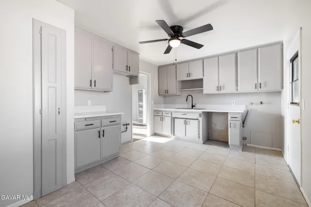 a kitchen with a stove a sink and a refrigerator
