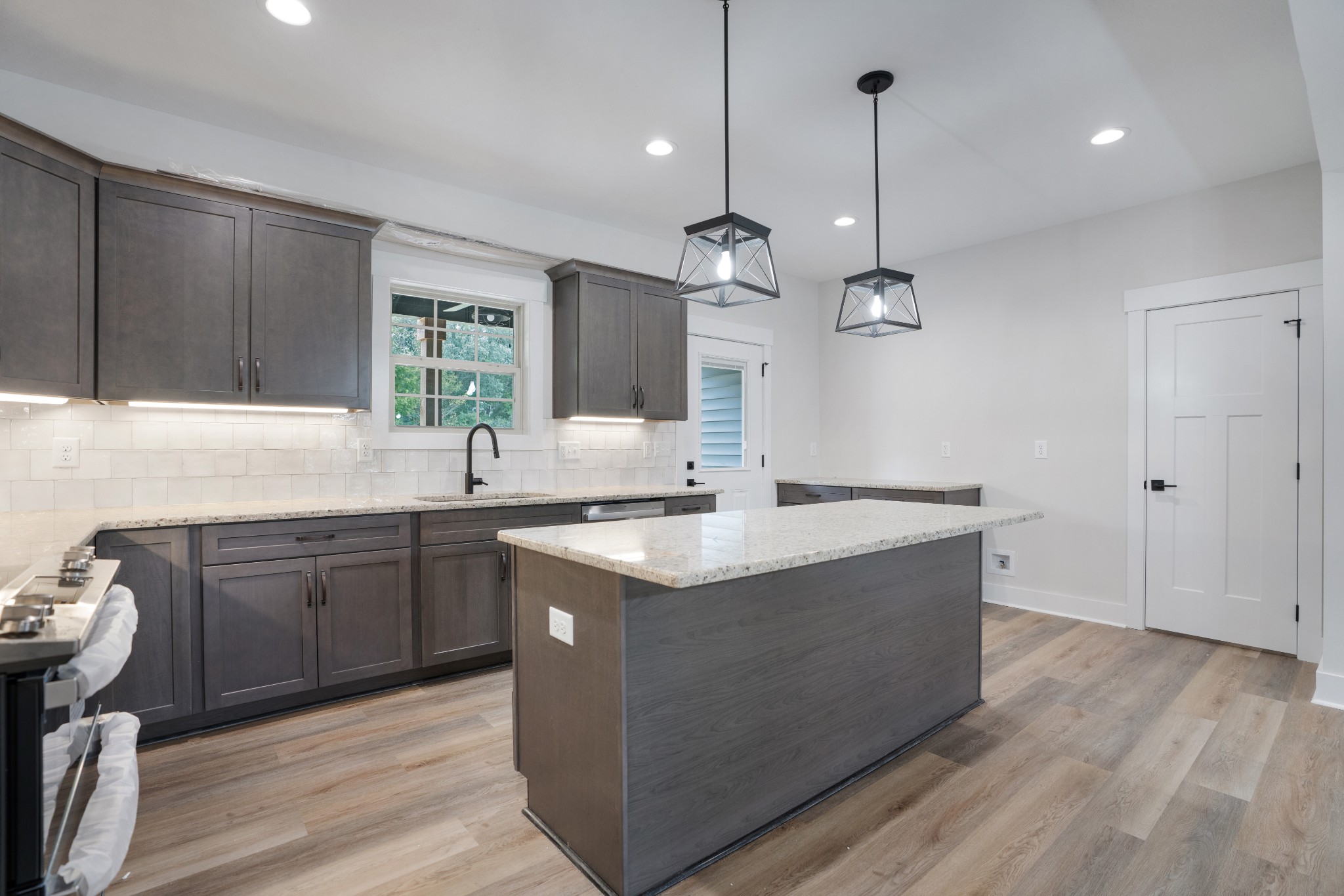 2615 Cooper Creek Road Woodlawn, TN 37191 - Photo 12 of 30 a kitchen with stainless steel appliances granite countertop a sink a stove and a wooden floors