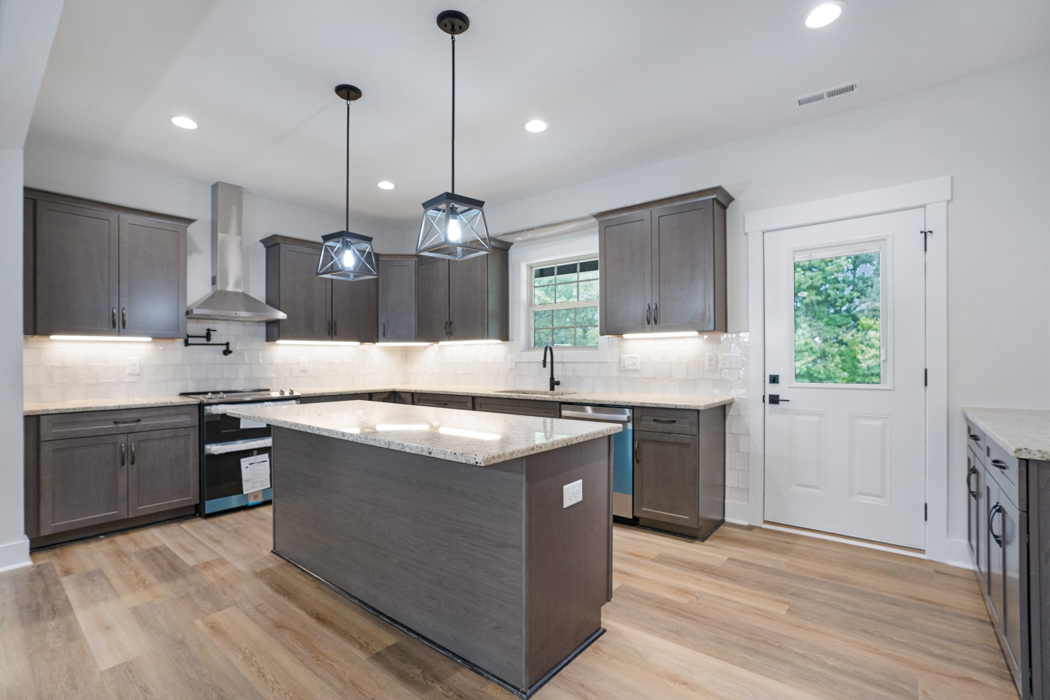 2615 Cooper Creek Road Woodlawn, TN 37191 - Photo 13 of 30 a kitchen with stainless steel appliances granite countertop wooden floors and sink