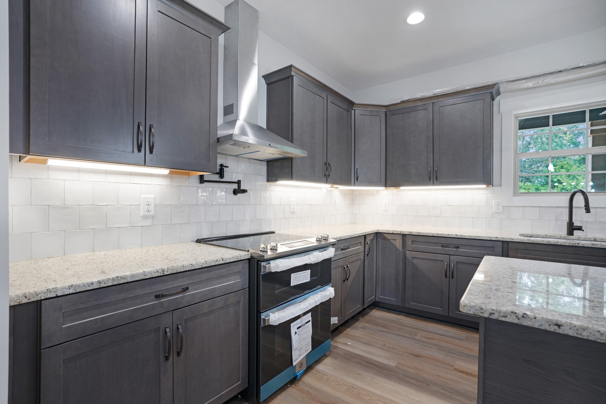 2615 Cooper Creek Road Woodlawn, TN 37191 - Photo 15 of 30 a kitchen with granite countertop wood cabinets stainless steel appliances and a window