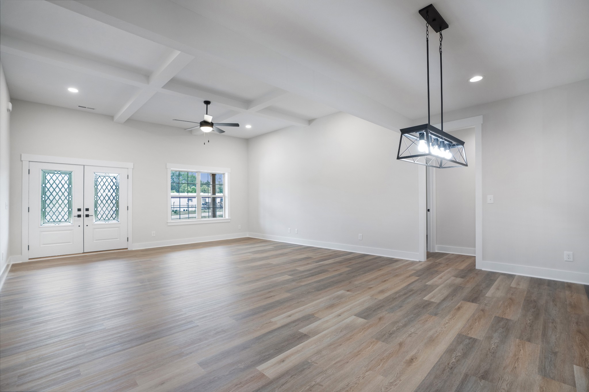 2615 Cooper Creek Road Woodlawn, TN 37191 - Photo 8 of 30 a view of an empty room with a ceiling fan and wooden floor