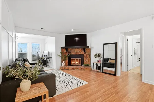 a living room with furniture fireplace and flat screen tv