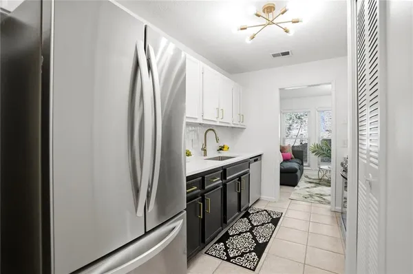 a kitchen with stainless steel appliances granite countertop a refrigerator and a stove