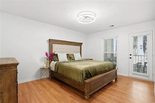 a bedroom with a bed and wooden floor