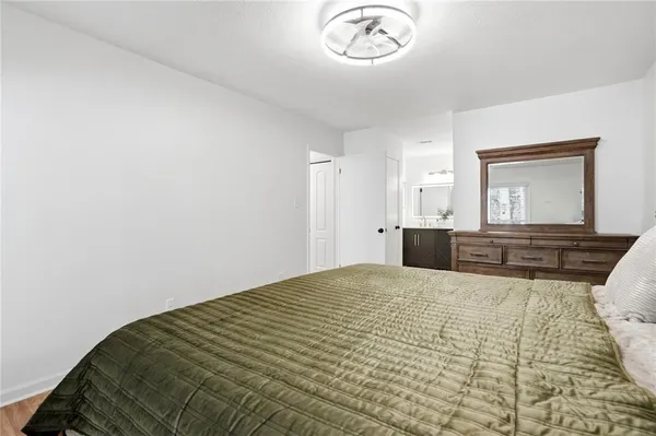 a bedroom with a large bed and a chandelier