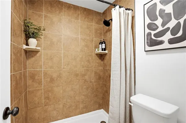 a bathroom with a toilet and shower
