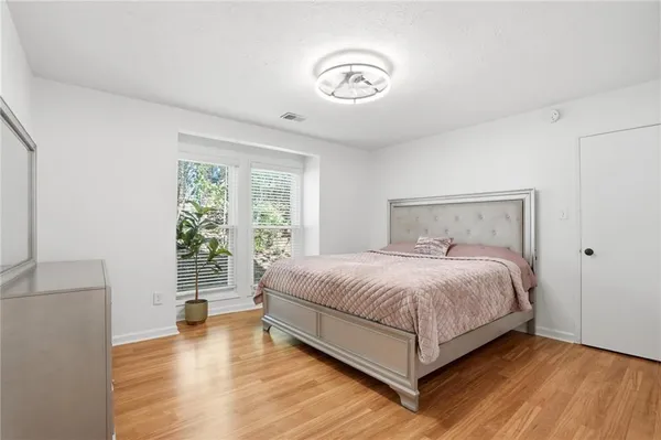 a bedroom with a bed and window