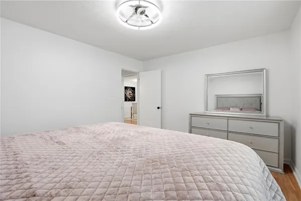 a bedroom with a bed and a mirror