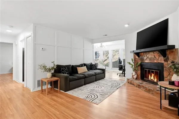 a living room with furniture a flat screen tv and a fireplace