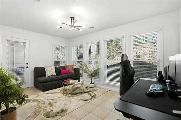 a living room with furniture and floor to ceiling windows