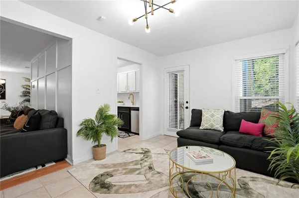 a living room with furniture potted plant and a window