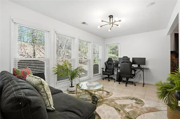 a living room with furniture and potted plants
