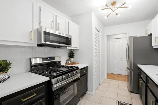 a kitchen with stainless steel appliances a stove a microwave and cabinets