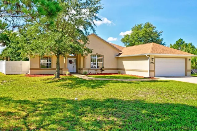 a front view of house with yard and green space
