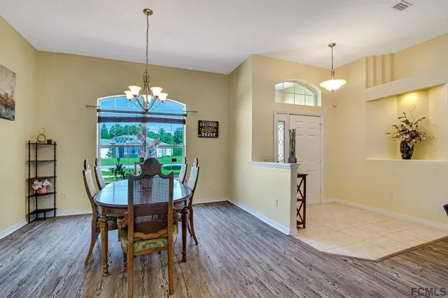 a view of a dining room with furniture wooden floor and chandelier