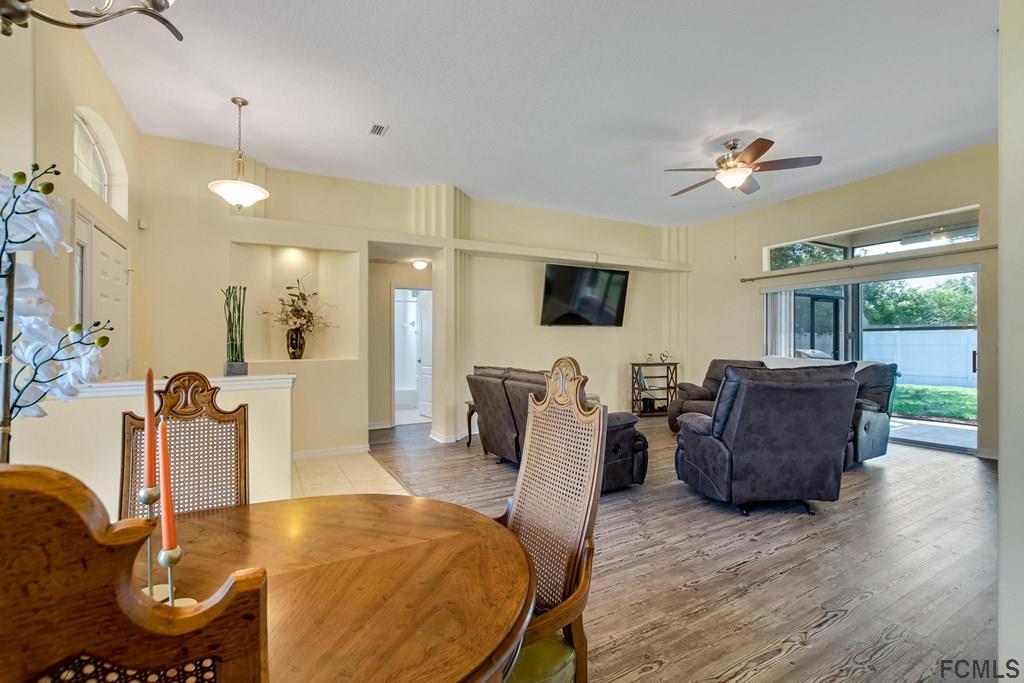 102 Ulysses Trail Palm Coast, FL 32164 - Photo 14 of 62 a living room with furniture and a flat screen tv