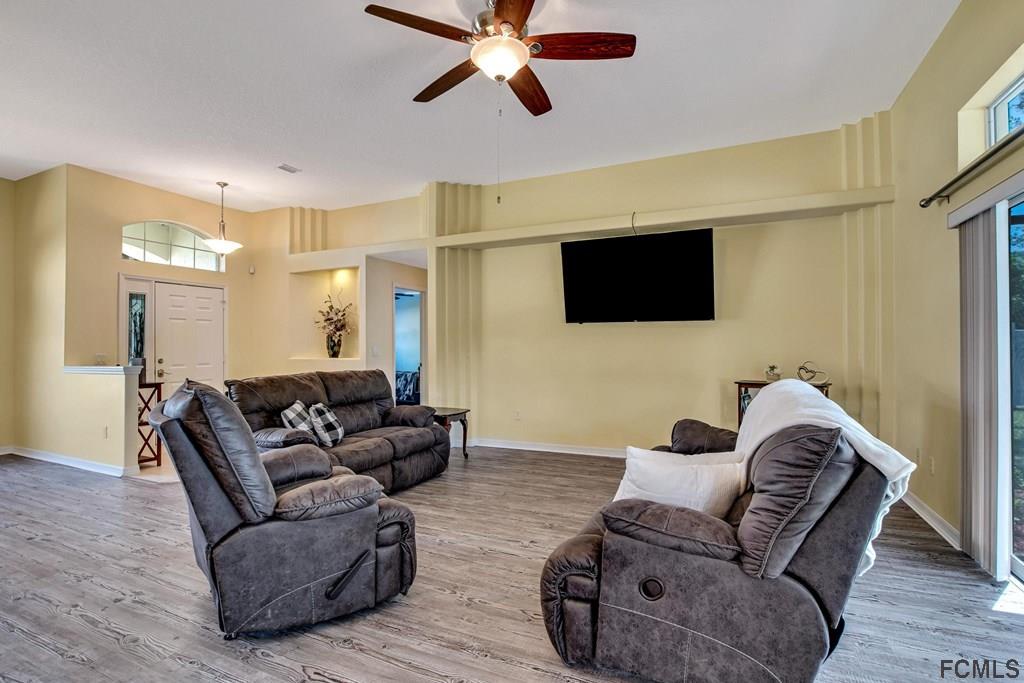 102 Ulysses Trail Palm Coast, FL 32164 - Photo 16 of 62 a living room with furniture and a flat screen tv