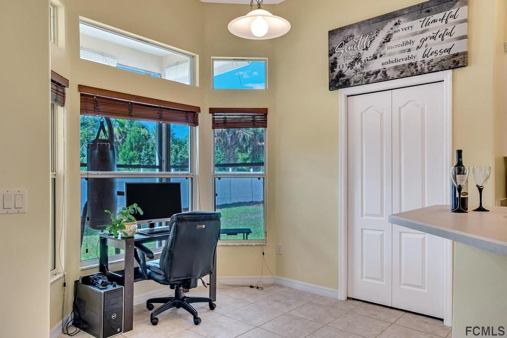102 Ulysses Trail Palm Coast, FL 32164 - Photo 19 of 62 a view of a workspace with furniture and a window