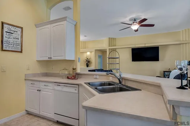 a kitchen with stainless steel appliances a sink a stove and a microwave