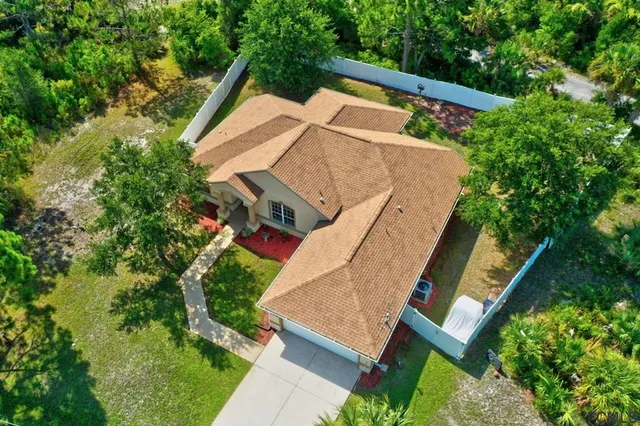 an aerial view of a house with a yard