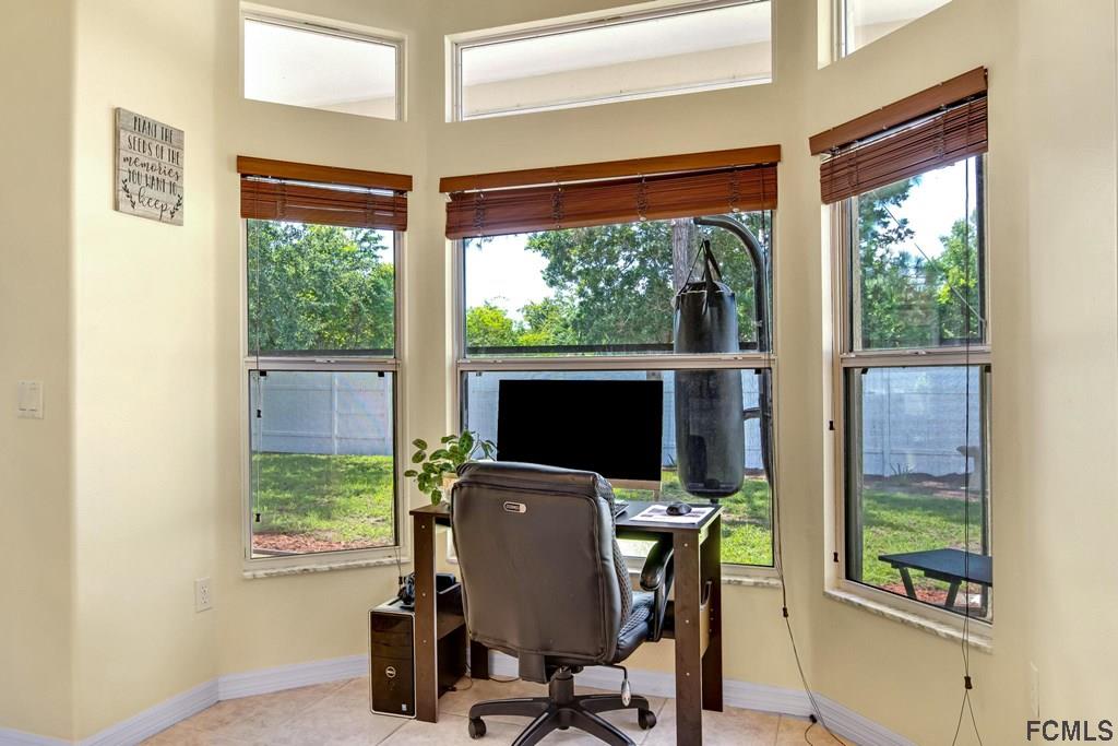 102 Ulysses Trail Palm Coast, FL 32164 - Photo 24 of 62 a view of a workspace with furniture and a window