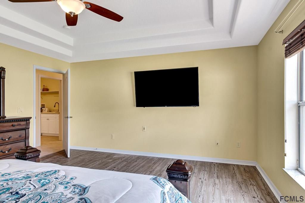 102 Ulysses Trail Palm Coast, FL 32164 - Photo 28 of 62 a bedroom with a bed and wooden floor