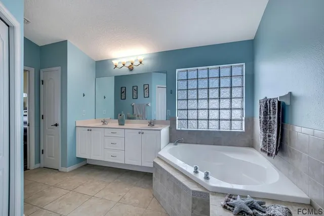 a bath tub sitting in a bathroom next to a window