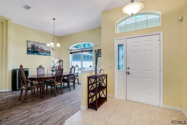 a view of a a dining room with furniture window and wooden floor