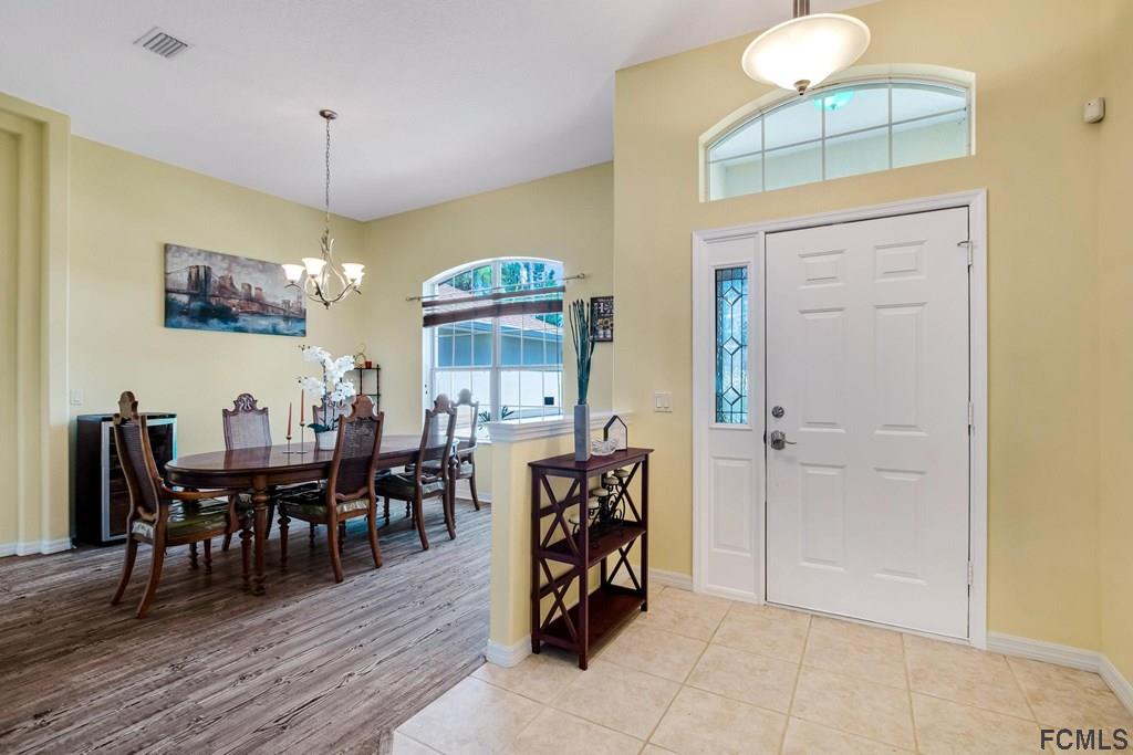102 Ulysses Trail Palm Coast, FL 32164 - Photo 3 of 62 a view of a a dining room with furniture window and wooden floor