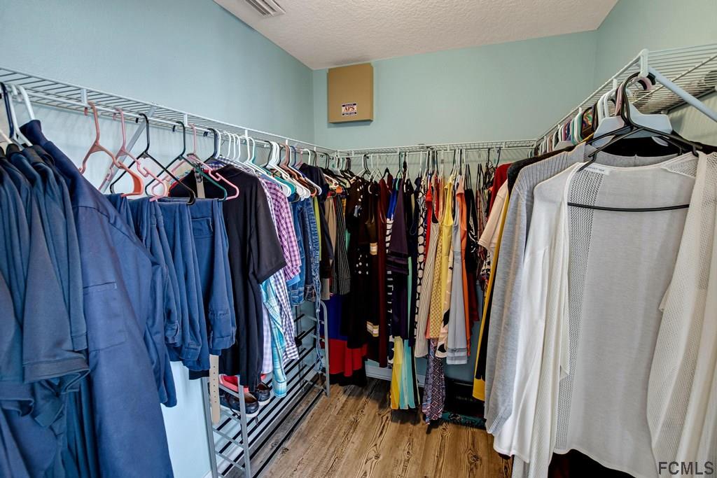 102 Ulysses Trail Palm Coast, FL 32164 - Photo 32 of 62 a view of walk in closet with clothes