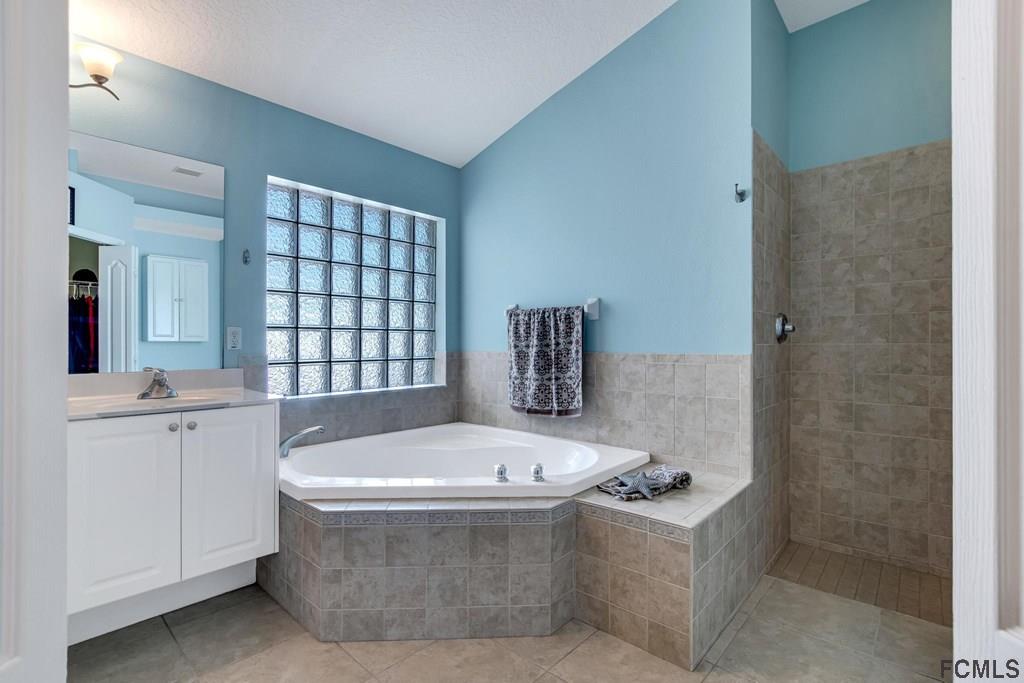 102 Ulysses Trail Palm Coast, FL 32164 - Photo 33 of 62 a bath tub sitting in a bathroom next to a window