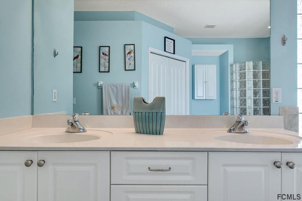 102 Ulysses Trail Palm Coast, FL 32164 - Photo 36 of 62 a bathroom with a sink and a mirror