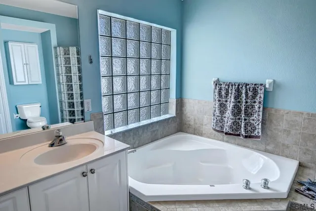 a bedroom with a bed and a mirror