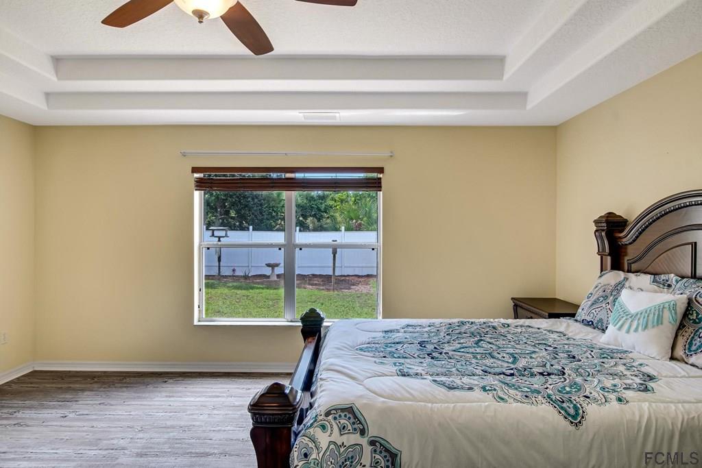 102 Ulysses Trail Palm Coast, FL 32164 - Photo 39 of 62 a bedroom with a bed and a window