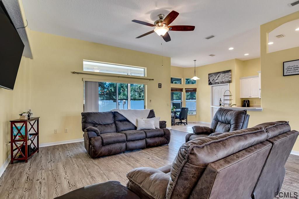 102 Ulysses Trail Palm Coast, FL 32164 - Photo 4 of 62 a living room with furniture ceiling fan and a window