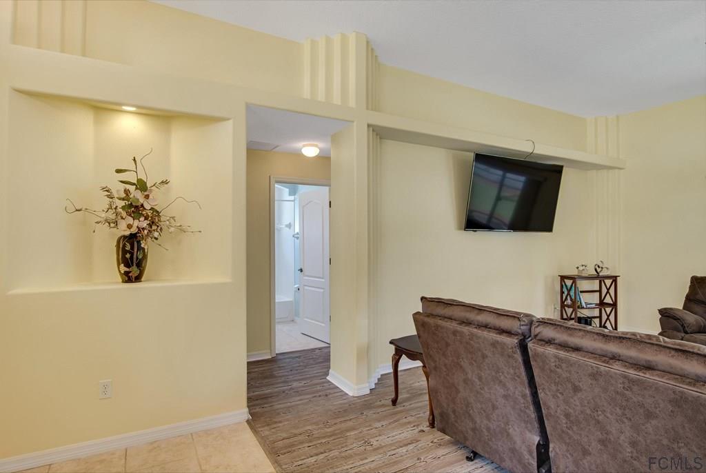 102 Ulysses Trail Palm Coast, FL 32164 - Photo 41 of 62 a living room with furniture and a flat screen tv