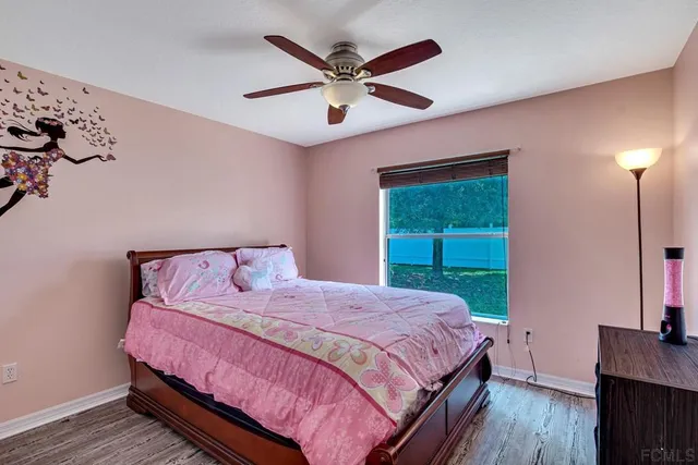 a view of a yard with a fence and a tree